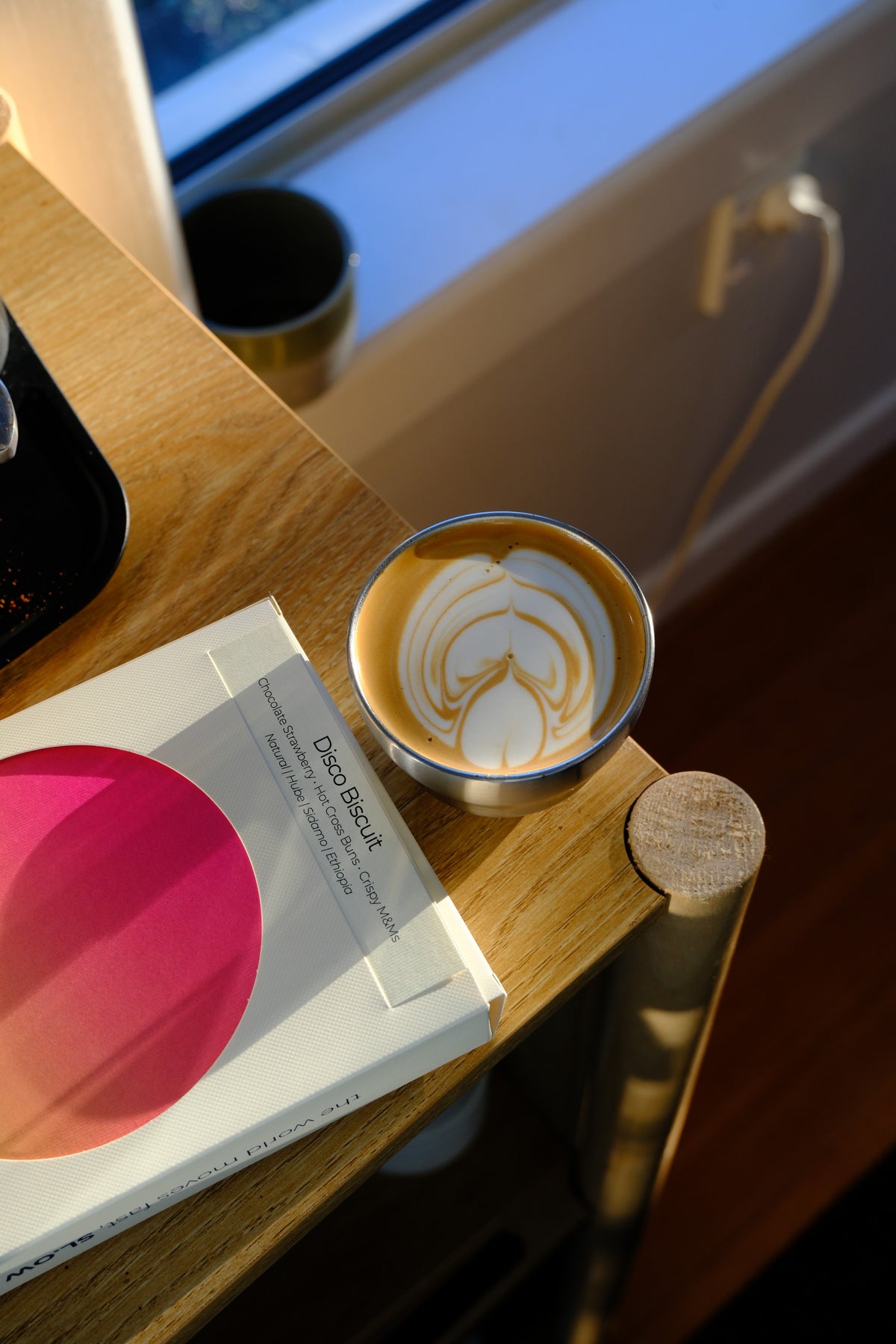 Disco Biscuit box with a flat white, from above