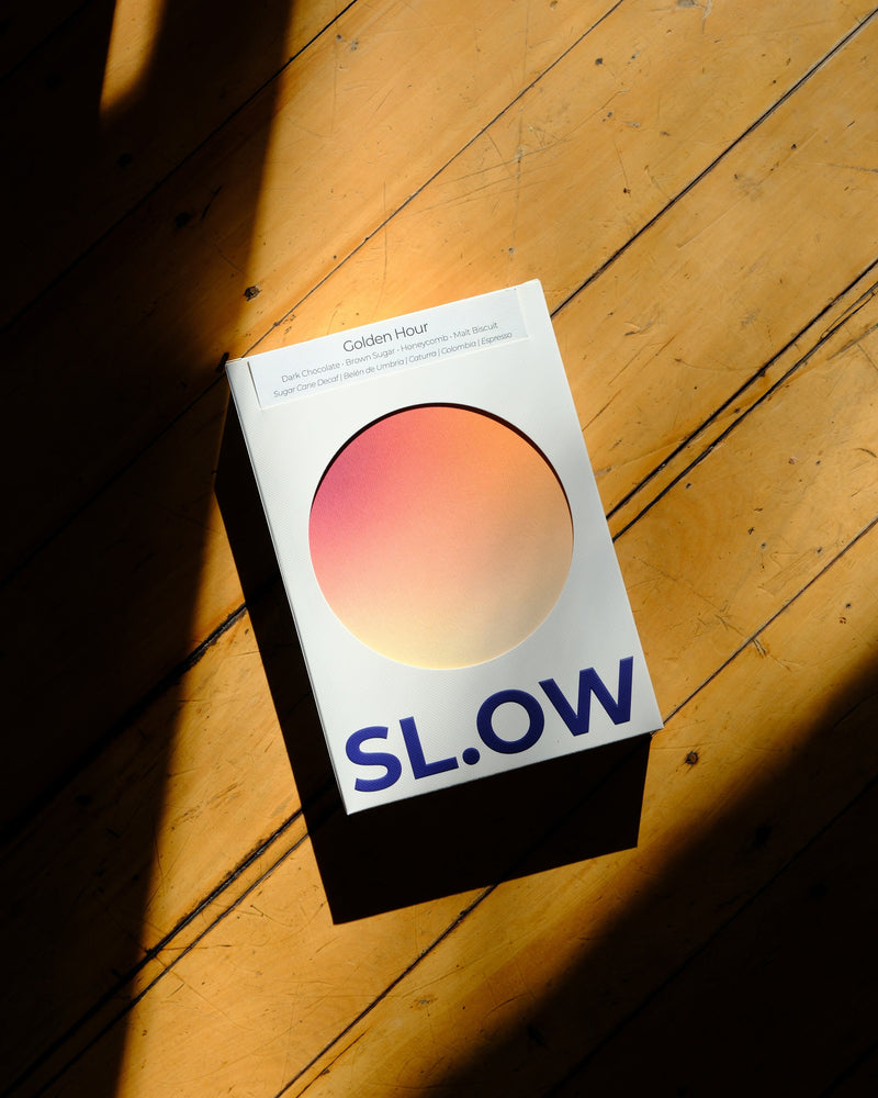 Golden Hour 200g box on wooden floor in morning light